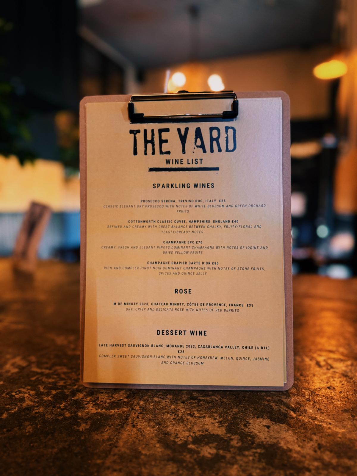 Intimate table setting with candles at The Yard Café evening event